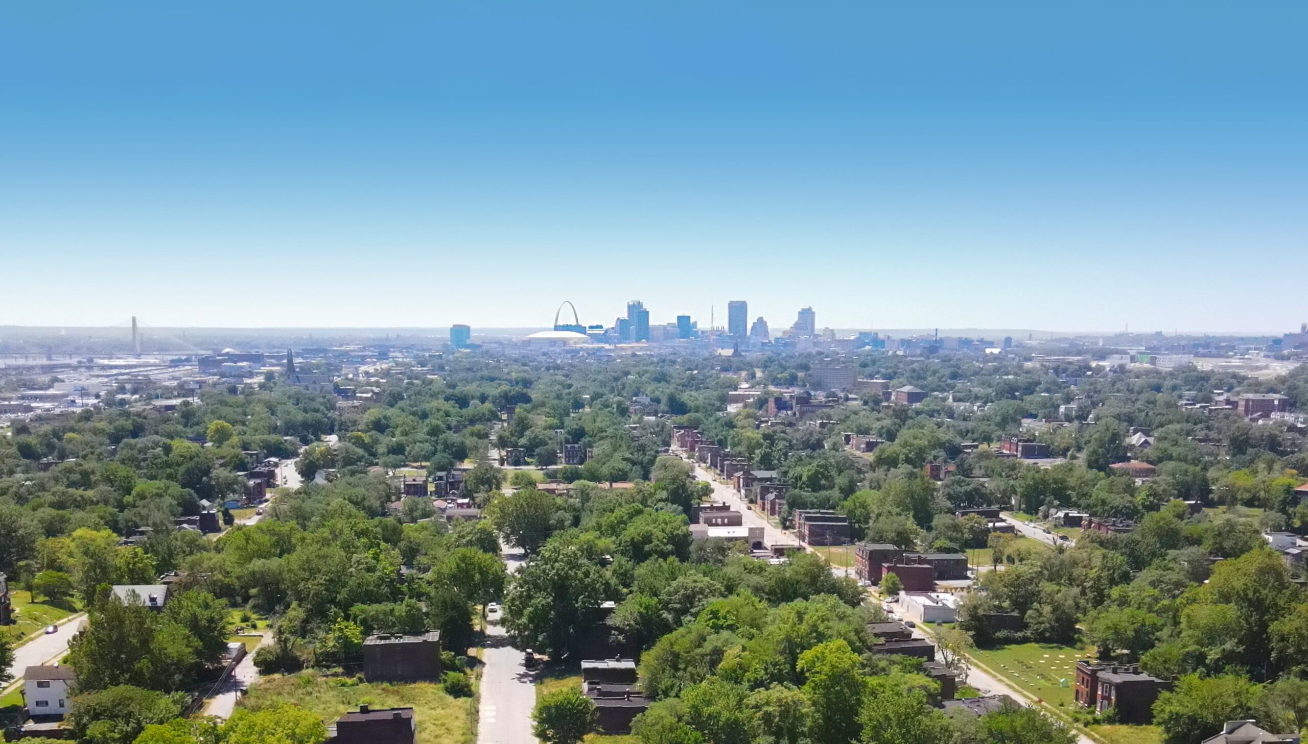 An aerial view of St. Louis from the north. The Gateway Arch and downtown are in the distance.