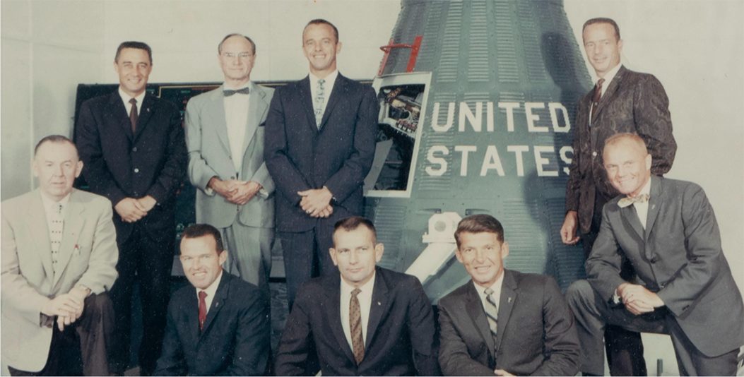 James S. McDonnell with the Mercury 7 astronauts and a space capsule.
