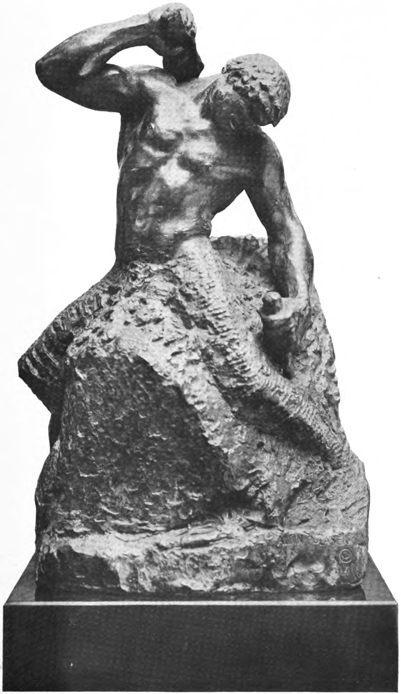 Sculpture of a man carving himself out of rock.
