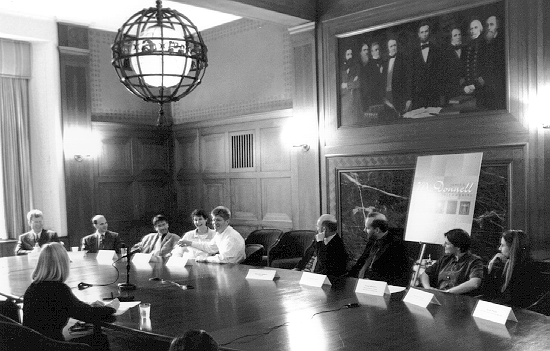 Centennial Fellows seated around a table at the National Academy of Sciences during a media interview.