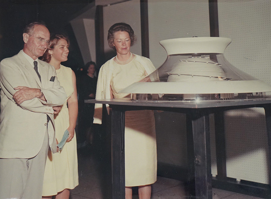 James S. McDonnell and family members standing next to a model of St. Louis's planetarium.