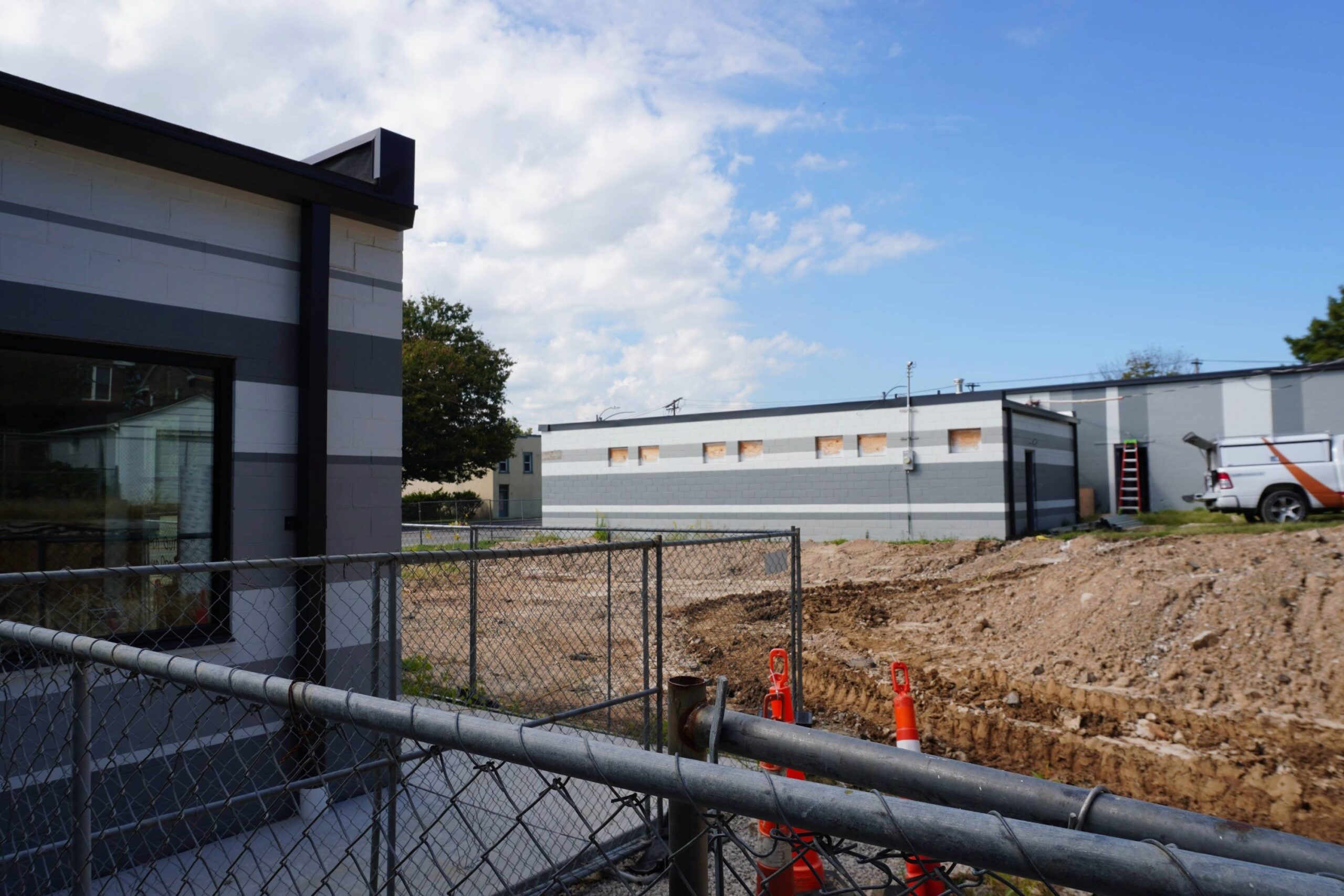 View of two buildings with a construction site in between them.