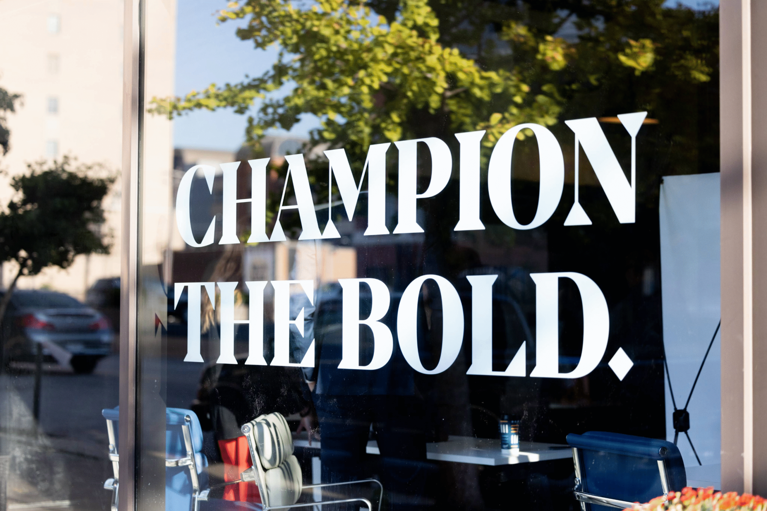 Window with a decal reading Champion the Bold.