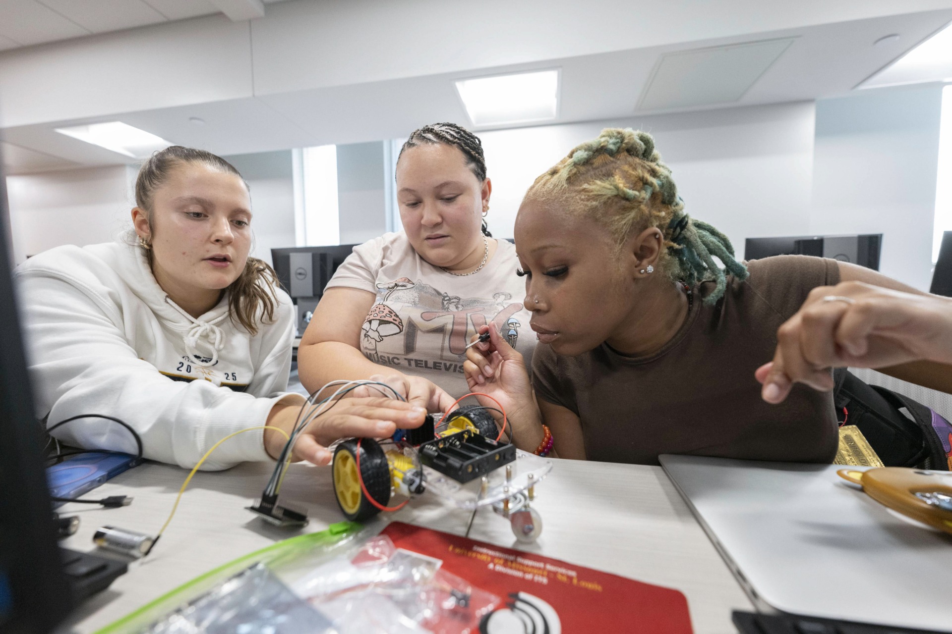 UMSL Engineering students working on a robotic car.