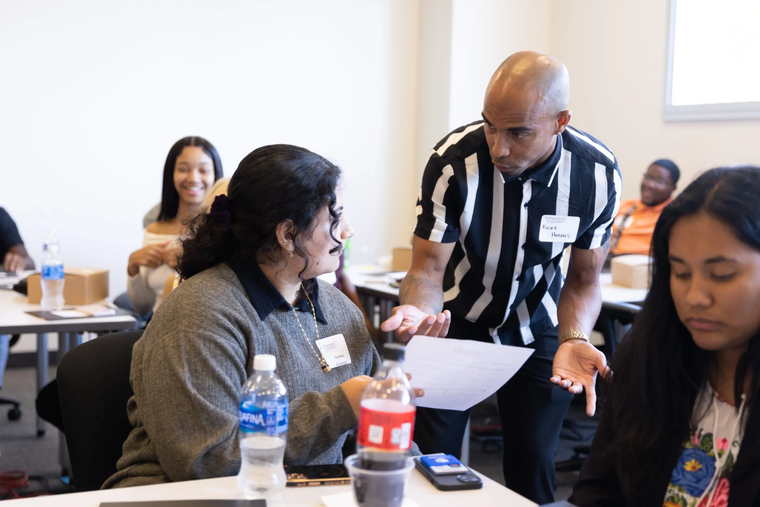 Ricky Hughes of The Scholarship Foundation of St. Louis interacting with a student at an event.